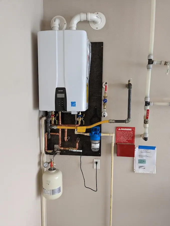 Professional plumber installing copper piping in a Gilroy home